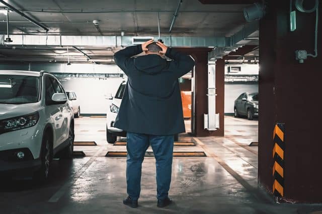 Stolen car. Surprised man discovered loss of car in underground garage parking lot